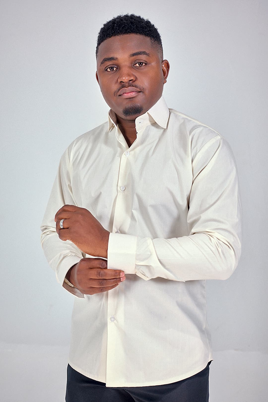 Cream shirt, cuff being fastened